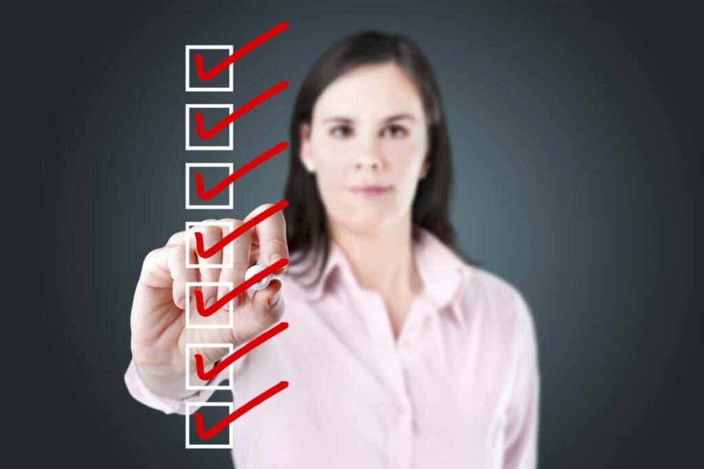 TFSA Rules for Holding U.S. Stocks: What Investors Need to Know woman checks off all the boxes