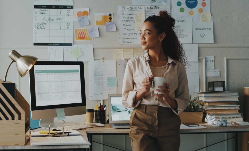 Down 24%: This Monthly Dividend Stock Is a Must-Buy A worker drinks out of a mug in an office.